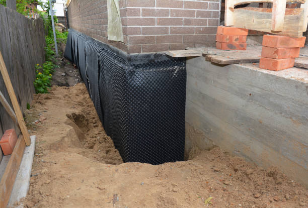 SJ Waterproofing Pros technician performing targeted Basement Waterproofing assessment in Wellston, MI